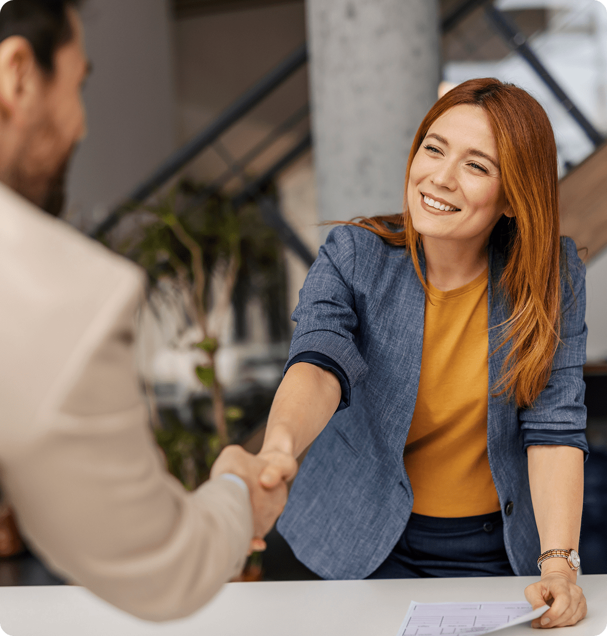 Smiling woman greeting a coworker